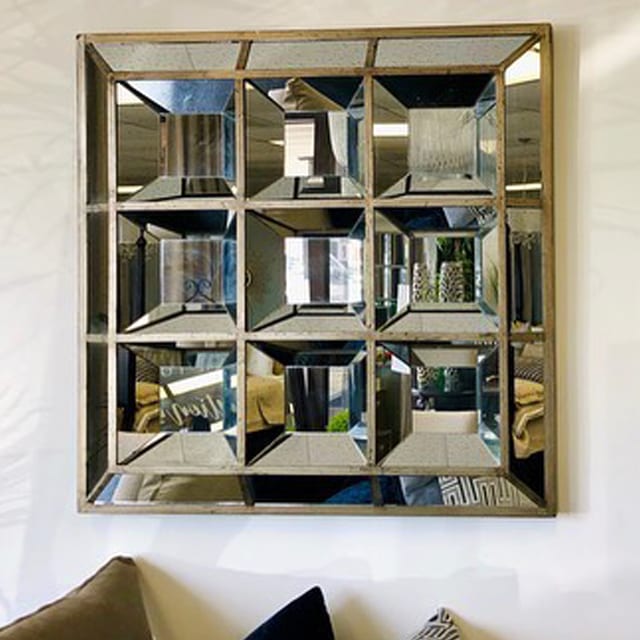 silver square mirror installed on the wall